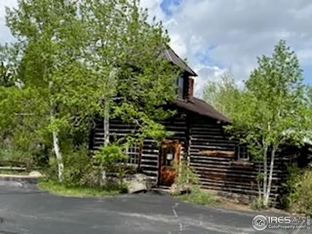 a backyard of a house with plants and trees
