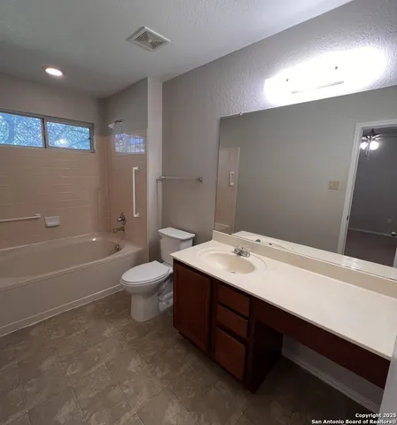 a bathroom with a sink toilet tub and shower