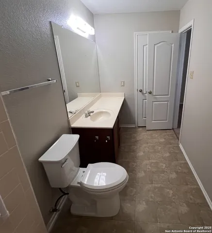 a white toilet sitting next to a bathroom sink