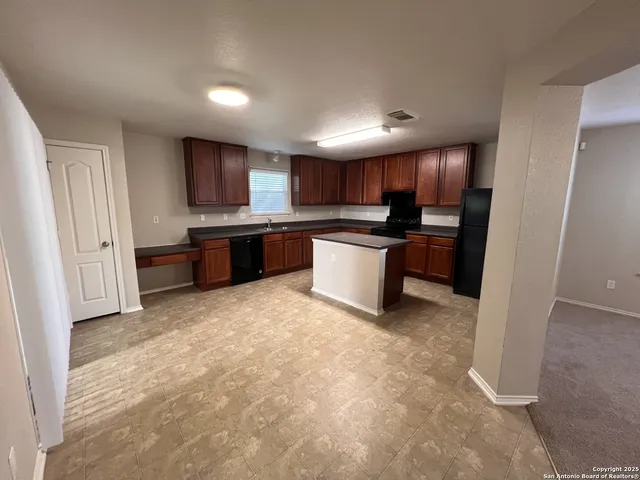 a kitchen with stainless steel appliances granite countertop a refrigerator sink and cabinets