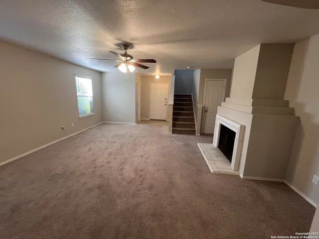 wooden floor in an empty room with a fireplace