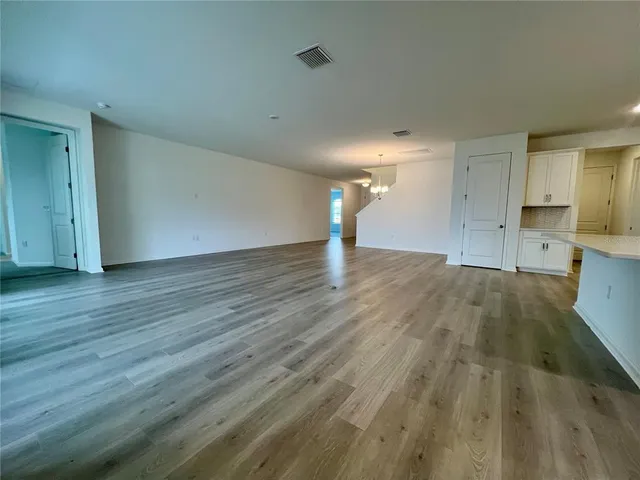 a view of a kitchen with wooden floor