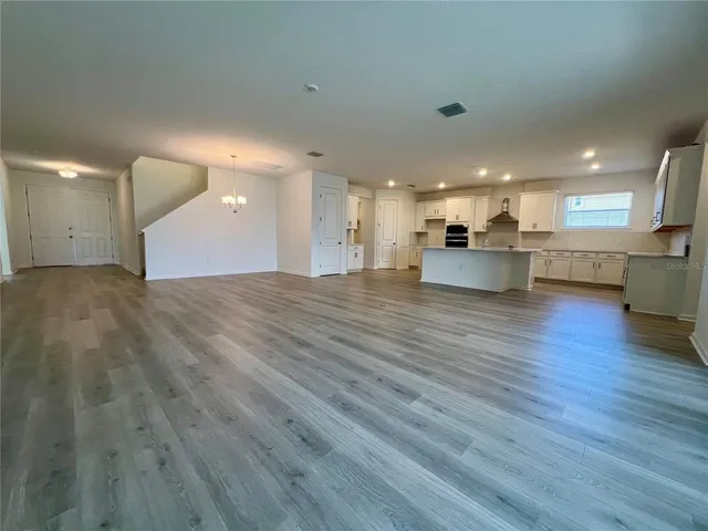 a view of kitchen with cabinets and wooden floor