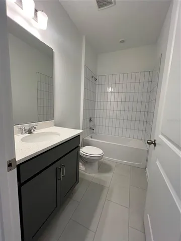 a bathroom with a double vanity sink toilet and shower