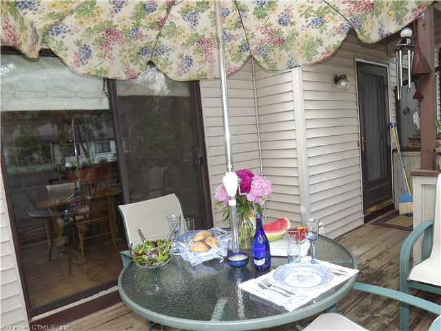 124 Cottonwood Road, Unit 124 Newington, CT 06111 - Photo 1 of 1 a dining room with furniture and wooden floor