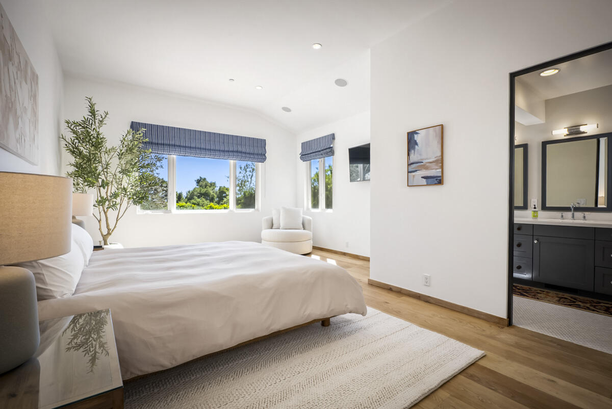 1190 Garden Lane Montecito, CA 93108 - Photo 25 of 43 a bedroom with a large bed and a chandelier