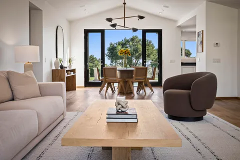 a bedroom with a large bed and a flat tv screen