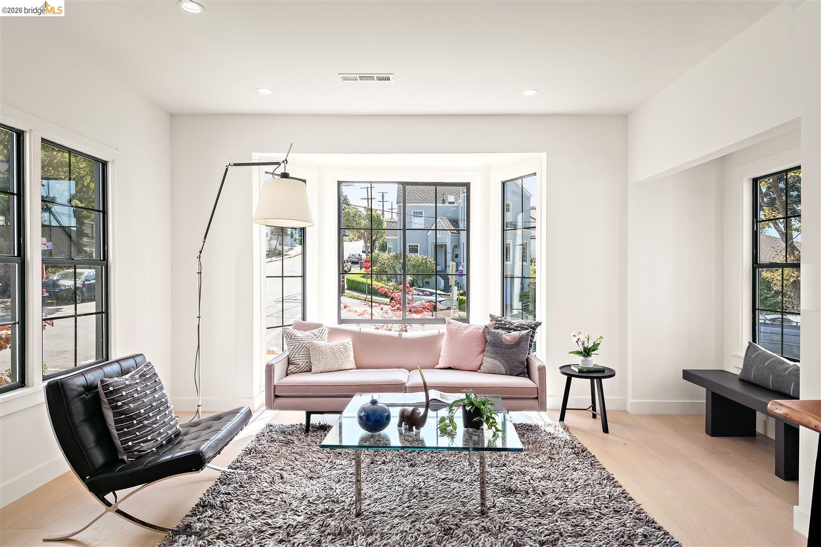 1668 Arch Street Berkeley, CA 94709 - Photo 13 of 78 Light wood-finish flooring, recessed lighting, expansive bay window, multiple windows with dark frames, and a built-in bench