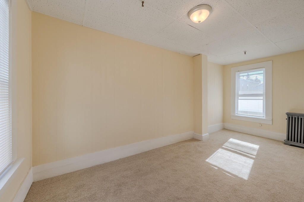 348 Walker Street Lowell, MA 01851 - Photo 6 of 20 an empty room with windows