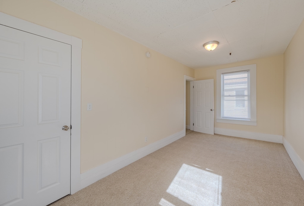 348 Walker Street Lowell, MA 01851 - Photo 7 of 20 a view of an empty room with a window
