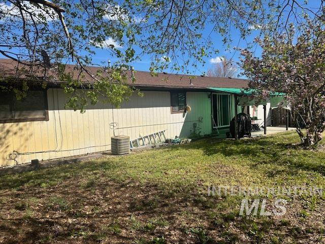 601 Riggs Avenue Emmett, ID 83617 - Photo 16 of 46 Rear view of house featuring a patio and a lawn