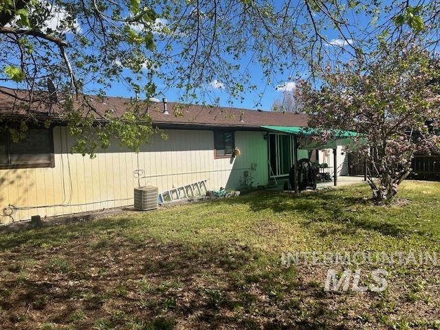 601 Riggs Avenue Emmett, ID 83617 - Photo 18 of 46 Rear view of house featuring a patio area and a lawn