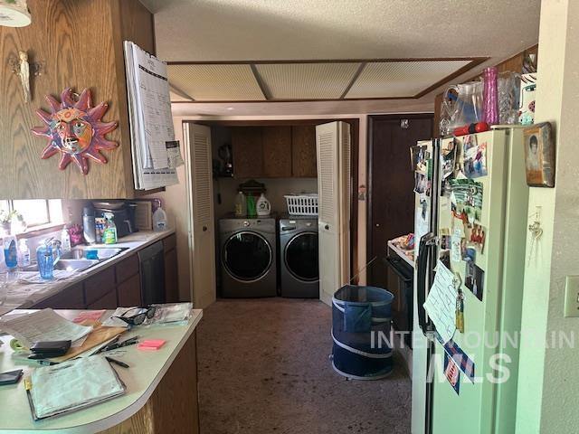 601 Riggs Avenue Emmett, ID 83617 - Photo 21 of 46 Kitchen with light countertops, freestanding refrigerator, washing machine and clothes dryer, and dishwasher