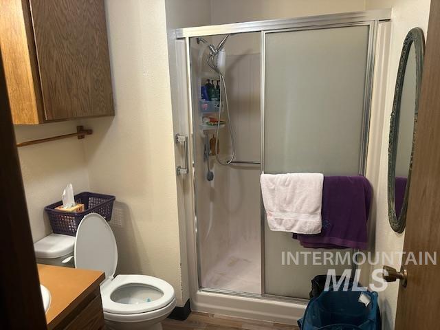 601 Riggs Avenue Emmett, ID 83617 - Photo 24 of 46 Full bathroom featuring vanity, a stall shower, and dark wood finished floors