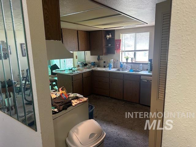 601 Riggs Avenue Emmett, ID 83617 - Photo 28 of 46 Kitchen featuring a textured wall, light countertops, a textured ceiling, dishwasher, and dark wood finish cabinetry