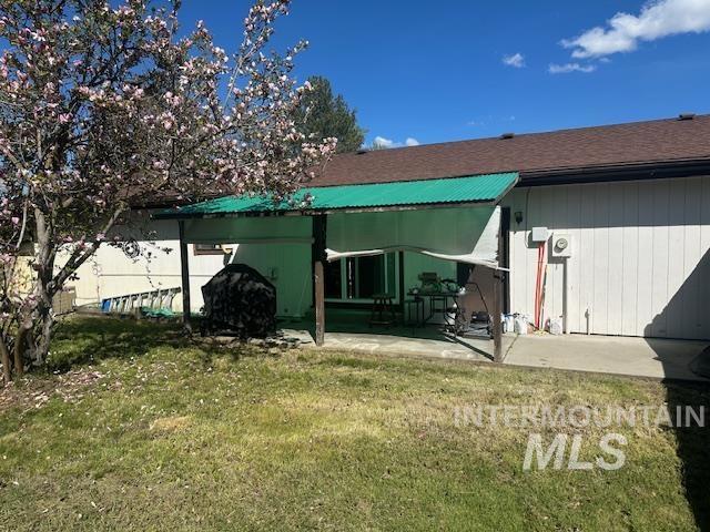 601 Riggs Avenue Emmett, ID 83617 - Photo 33 of 46 Back of property with a lawn, a patio, and a shingled roof
