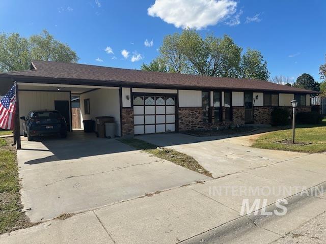 601 Riggs Avenue Emmett, ID 83617 - Photo 8 of 46 Ranch-style home with a carport, driveway, brick siding, and a front lawn