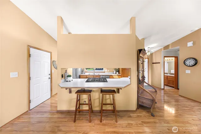 a view of a workspace with furniture and wooden floor