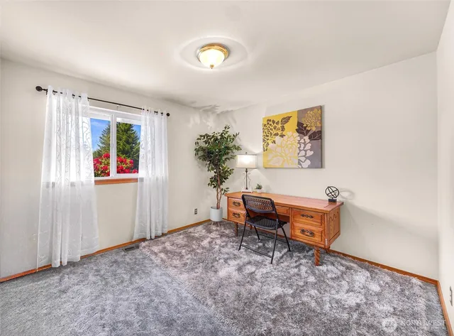 a view of a workspace with furniture and window in livingroom