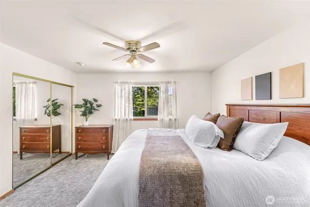 a bedroom with a large bed and a chandelier