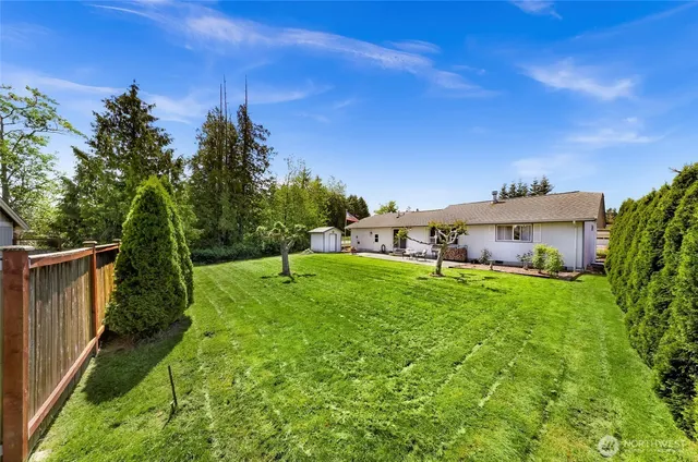 a yellow and red house with a yard