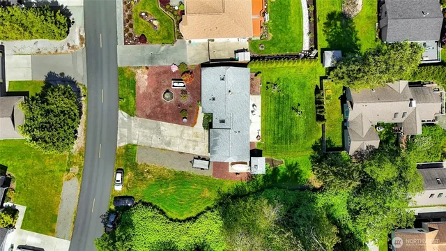 an aerial view of residential houses with outdoor space and street view