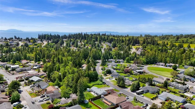 an aerial view of a houses with a yard