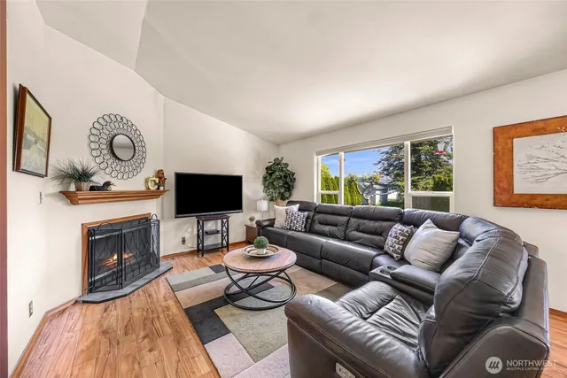 a living room with furniture a flat screen tv and a fireplace