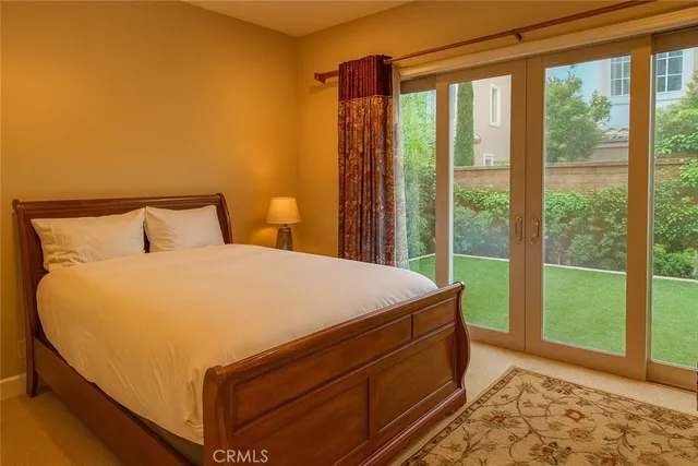 a bed sitting in a bedroom next to a window