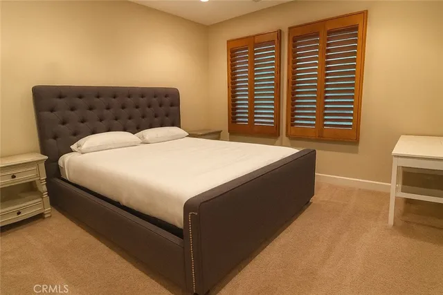 a bed sitting in a bedroom next to a window