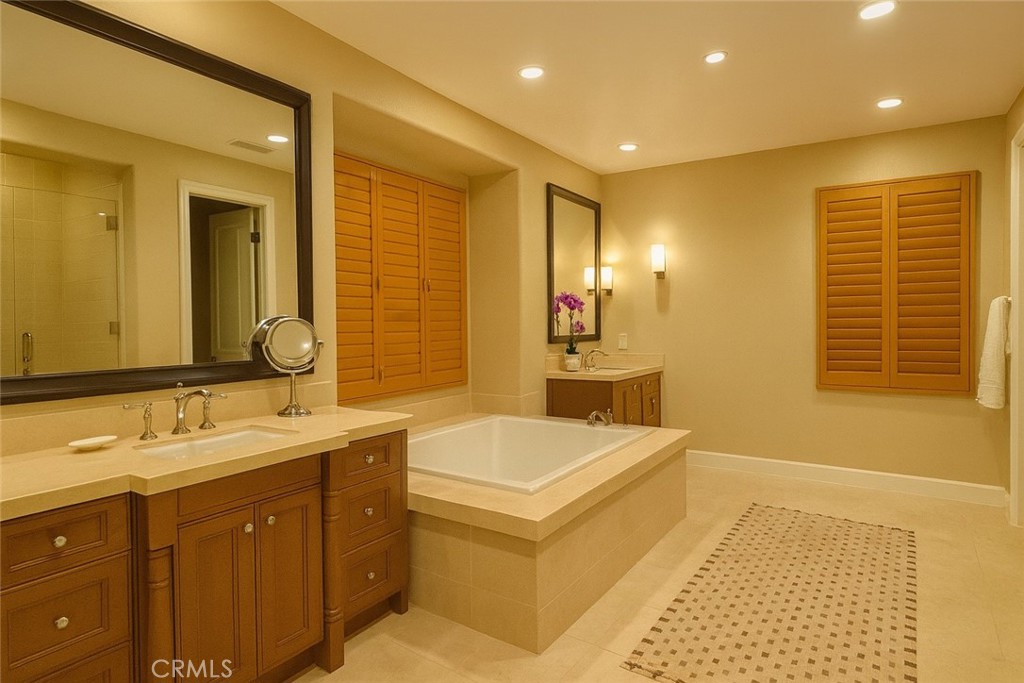 20 Tenderfoot Irvine, CA 92602 - Photo 16 of 26 a bathroom with a tub sink and mirror