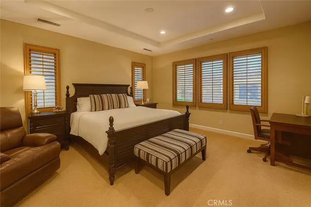 a spacious bedroom with a bed and a couch