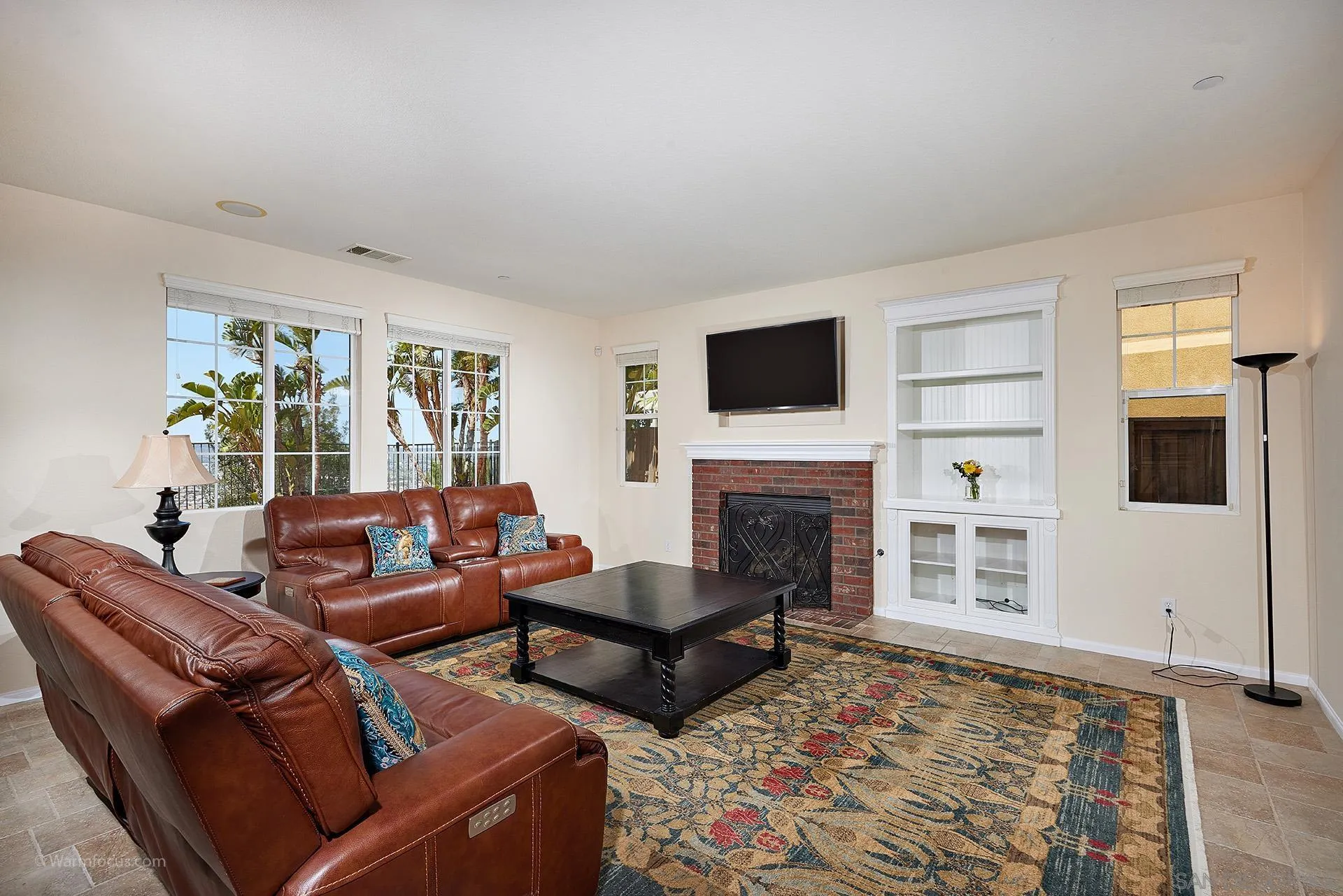 3025 Calico Street Santee, CA 92071 - Photo 11 of 59 a living room with furniture a flat screen tv and a fireplace
