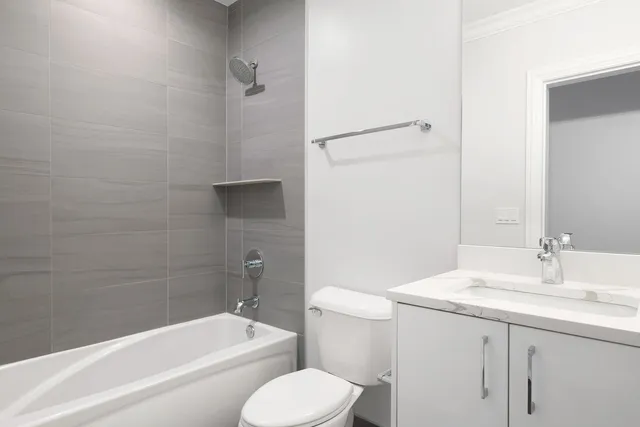 a bathroom with a granite countertop toilet a sink and bathtub
