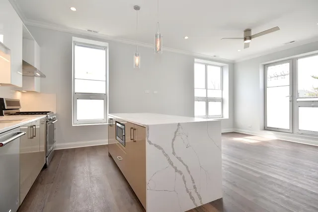 a kitchen with a sink a window a stove and a refrigerator