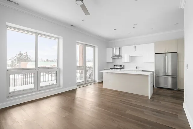 a view of kitchen with wooden floor and electronic appliances