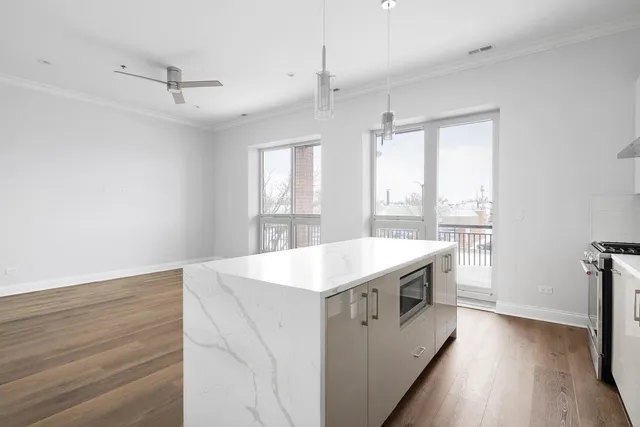 a kitchen with a stove and a wooden floor