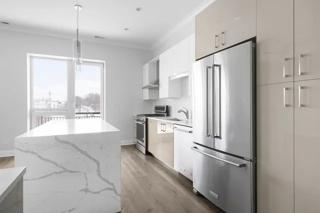 a kitchen with white cabinets and white appliances