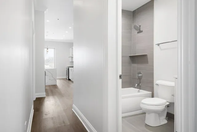 a bathroom with a toilet and a shower