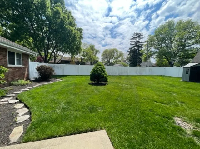 a backyard of a house with table and chairs