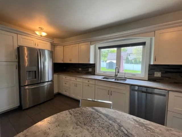 a kitchen with a refrigerator and a sink