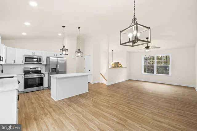 a view of kitchen with sink and refrigerator