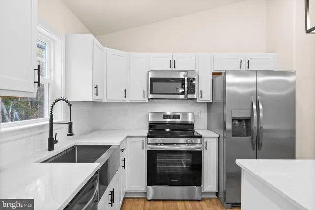 a kitchen with a sink stove and refrigerator