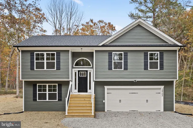 a front view of a house with a garage