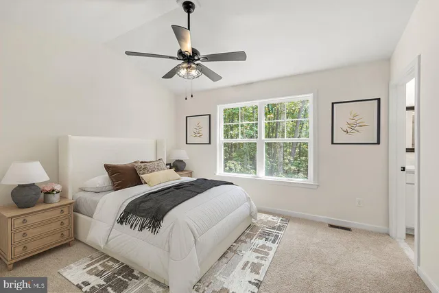 a bedroom with a large bed and a window