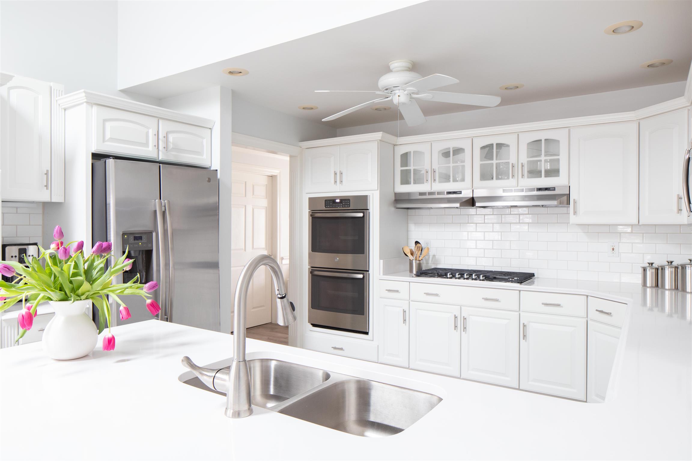6317 Lampkins Bridge Road College Grove, TN 37046 - Photo 1 of 28 a kitchen with stainless steel appliances kitchen island granite countertop a sink and white cabinets