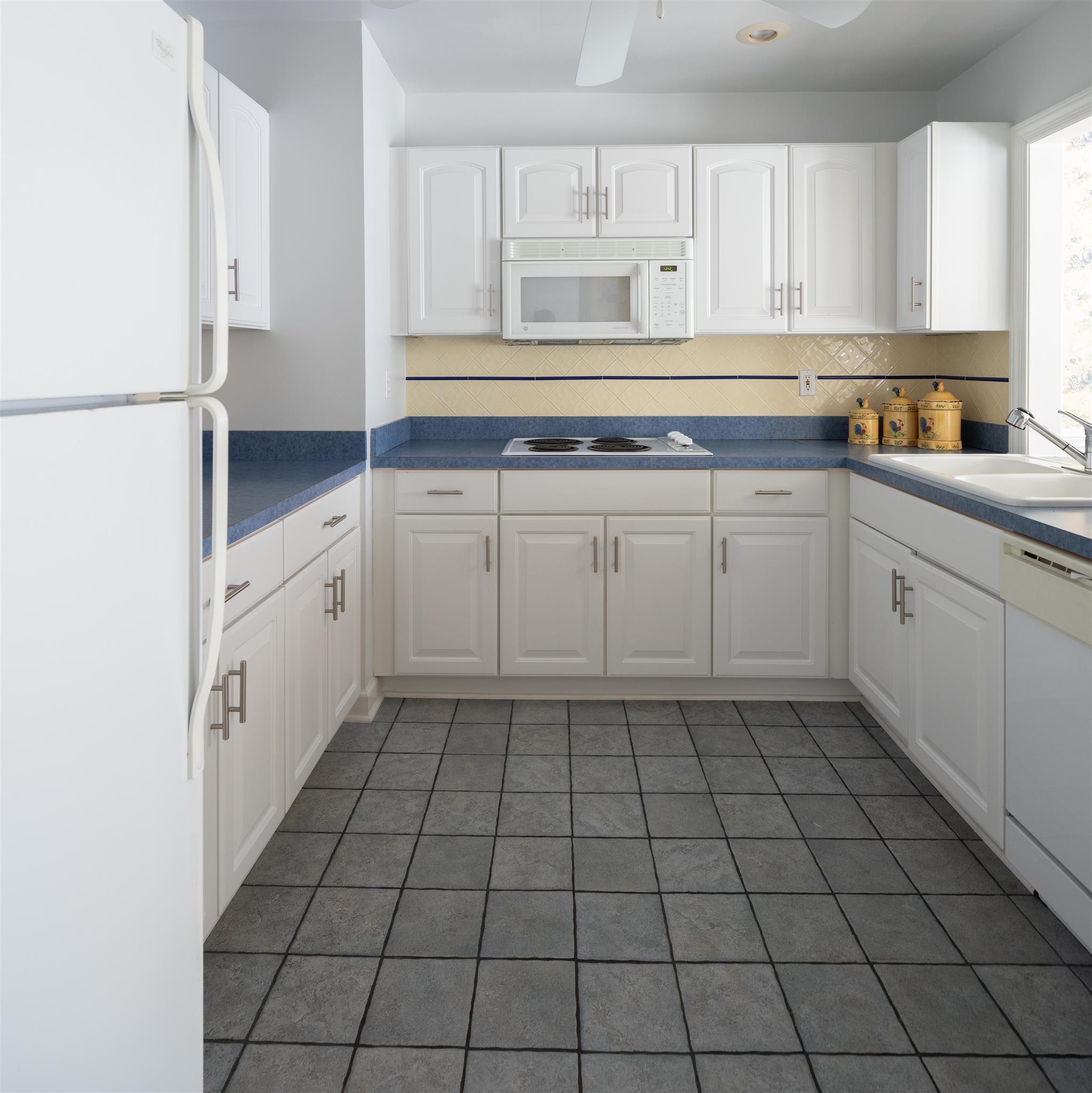 6317 Lampkins Bridge Road College Grove, TN 37046 - Photo 13 of 28 a kitchen with a white cabinets and a window