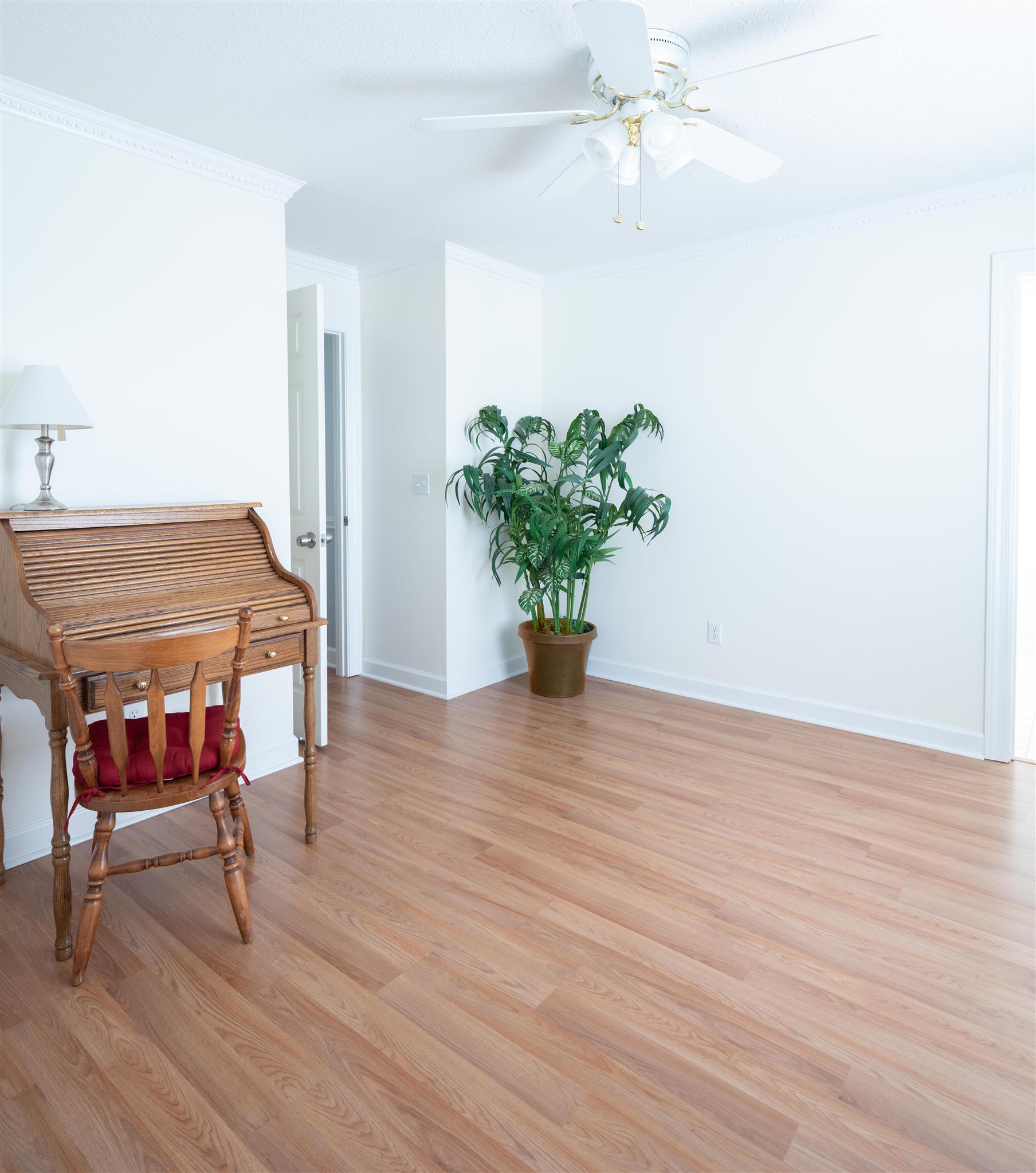 6317 Lampkins Bridge Road College Grove, TN 37046 - Photo 16 of 28 a dining room with furniture potted plants and wooden floor
