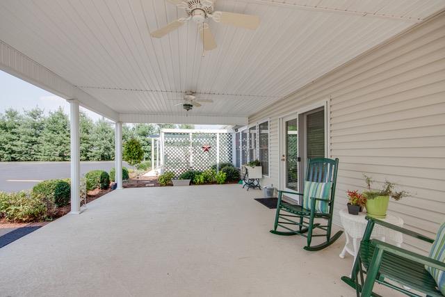 6317 Lampkins Bridge Road College Grove, TN 37046 - Photo 19 of 28 a view of a patio with table and chairs potted plants with wooden floor