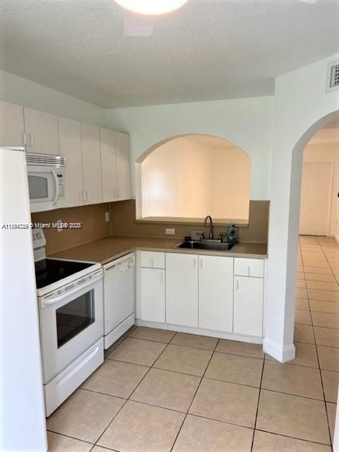 2920 Southeast 13th Road, Unit 10445 Homestead, FL 33035 - Photo 6 of 13 a kitchen with granite countertop white cabinets and white appliances